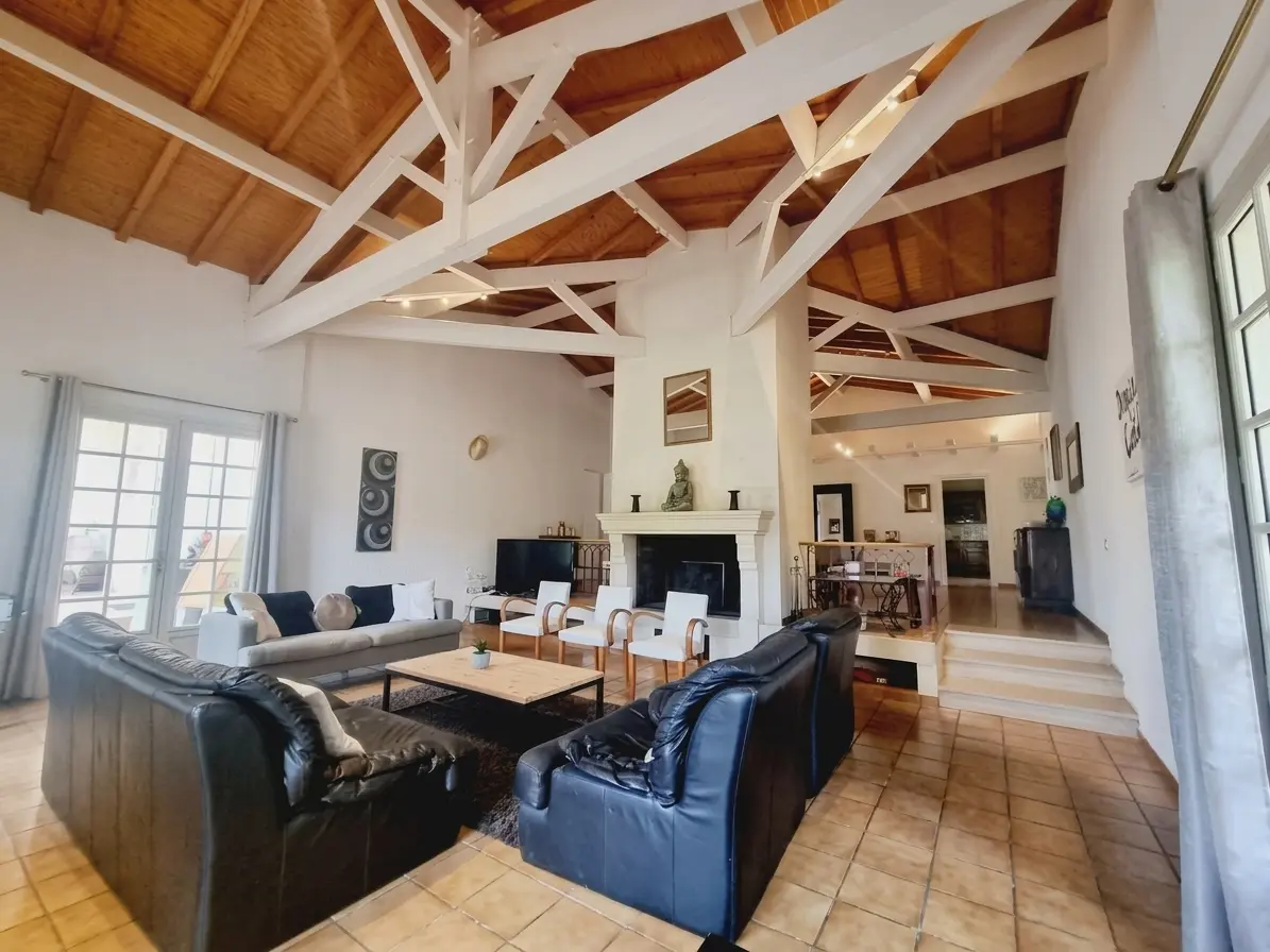 The cathedral-beamed lounge with a stone fireplace and leather sofas